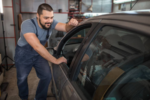 istock Young car mechanic talking with customer in garage 1306392826