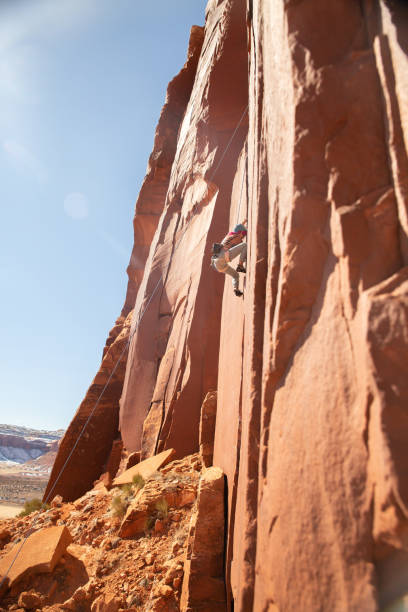 istock Female climber scales sandstone tower 1306392937