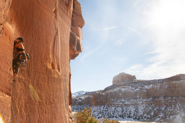 A female climber ascends the splitter crack Supercrack, in Indian Creek, UT.