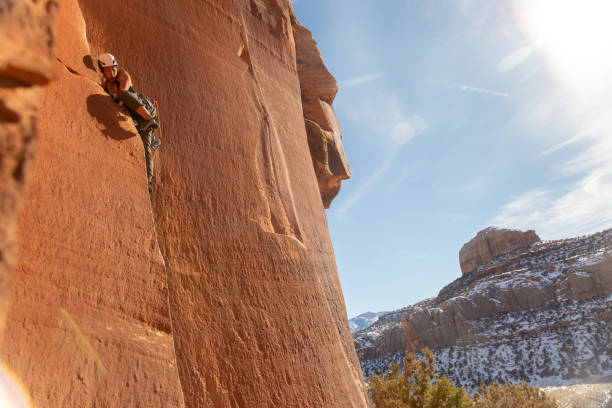A female climber ascends the splitter crack Supercrack, in Indian Creek, UT.