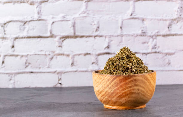 istock Thymus - Dried thyme herb in wooden bowl 1306393056