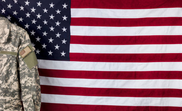 istock Military uniform with cloth US flag in background 1306394749