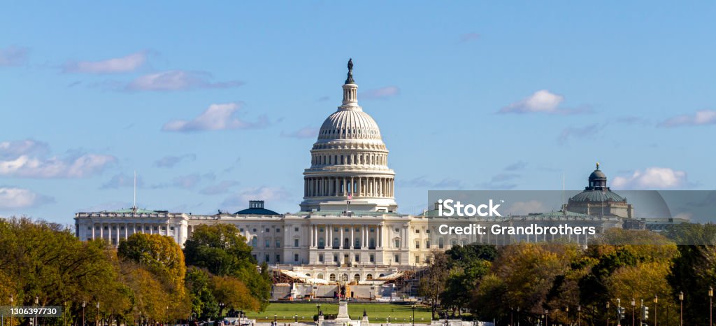 Panoramic image of the US Capitol building in Washington DC as seen from national mall Panoramic image of the US Capitol building in Washington DC as seen from national mall This iconic place holds senate and congress. It is a sunny autumn day and clear sky with a few clouds Capitol Building - Washington DC Stock Photo