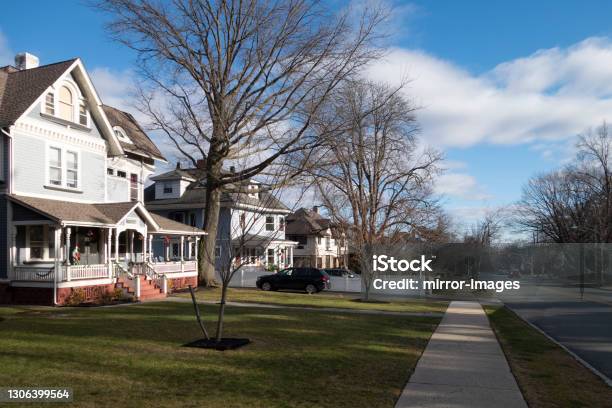 Street And Sidewalk Of Suburban Homes With Leafless Late Fall Winter Season Trees Stock Photo - Download Image Now