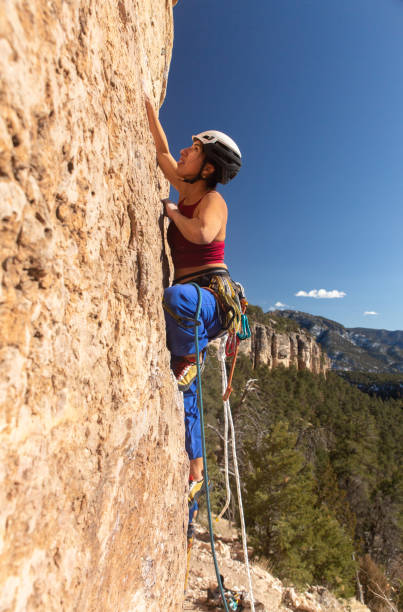 istock Female Climber analyzes start of climb 1306399647