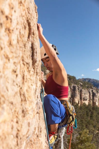 istock Female Climber analyzes start of climb 1306399659