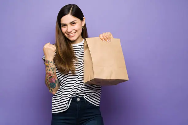 Photo of Excited latin woman about to eat delivery fast food