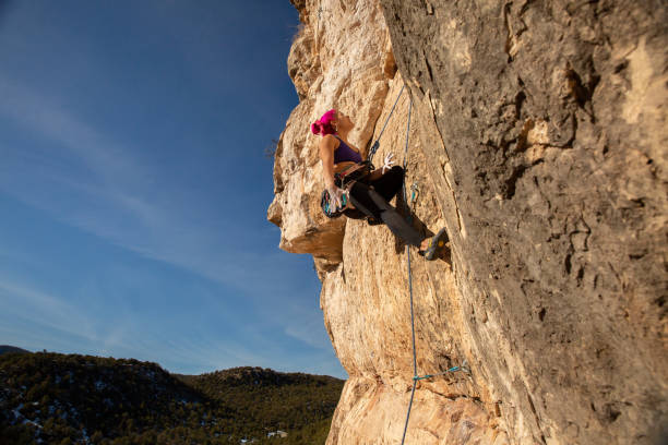 istock Female Climber analyzes start of climb 1306399845