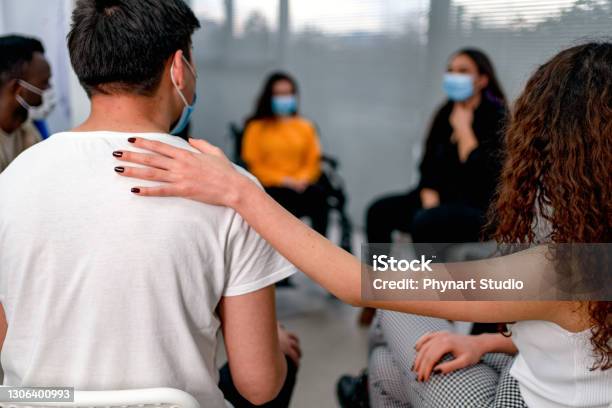 Support Group Patients Comforting At Therapy Session Stock Photo - Download Image Now