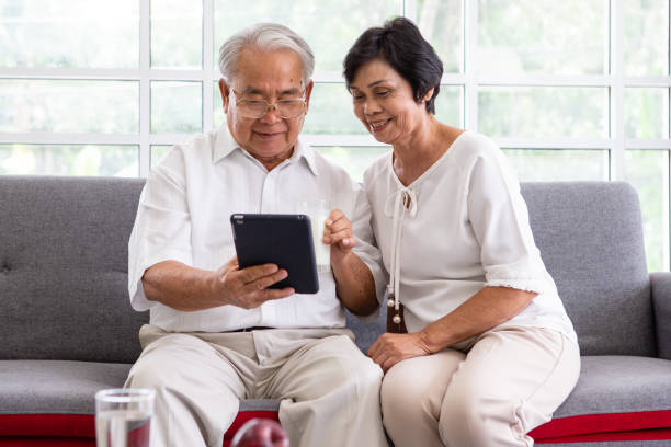 istock Senior couple watching digital tablet together at home 1306410343