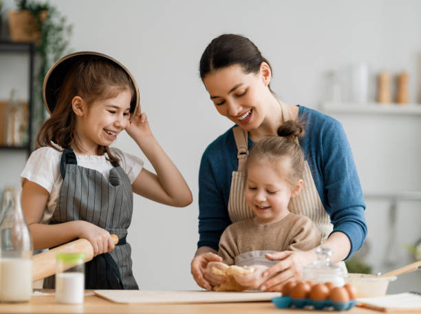 istock family are preparing bakery together 1306410448