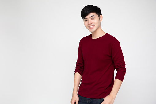 Young Asian man smiling and looking at camera isolated on white background