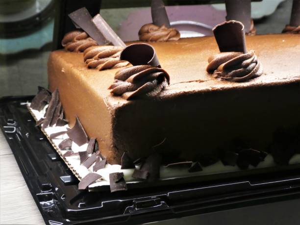 istock Beautifully Decorated Chocolate Cake Close Up (Rectangular Shape) - Chocolate Icing and Chocolate Pieces as a Decorative Topping 1306411866