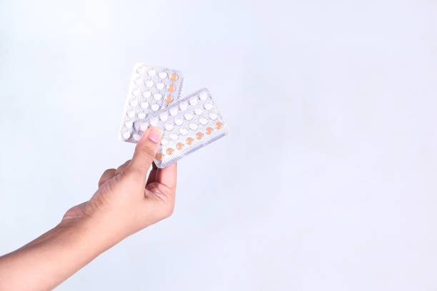 istock women hand golding birth control pills isolated on white 1306413725
