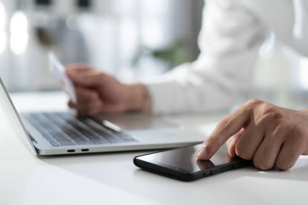 istock Cropped Hands Of man Making Card Payment While Using Laptop At Table 1306414510