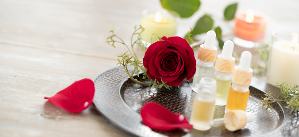 Essential Oils with a Rose and Candles