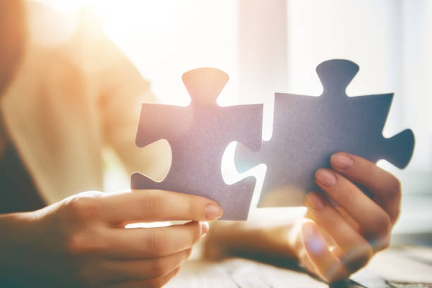 istock Woman connects couple puzzle piece 1306414792