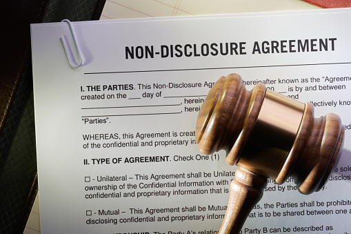 Non-Disclosure Agreement. Confidentiality Agreement on note pad, with gavel