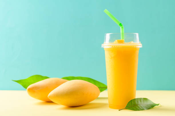 istock Fresh mango smoothie in a glass and ripe mango fruit 1306417701