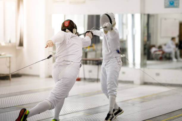 Male fencing athletes playing Fencing athletes training face guard sport photos stock pictures, royalty-free photos & images