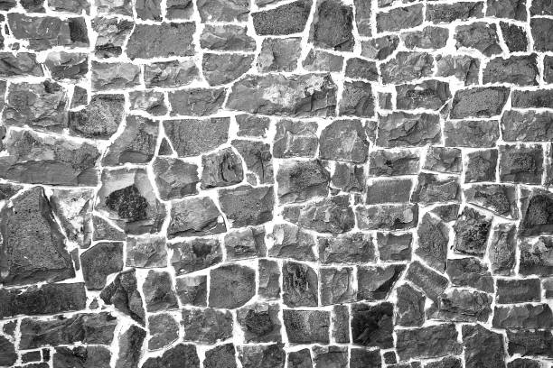 istock Stone wall of cobblestones background. View from the front. UNUSUAL SURFACE. 1306421875