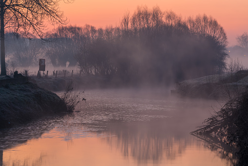 on a misty, icy Sunday morning along the river with the sun rising
