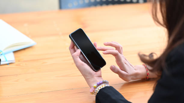 istock Close up view young female holding mock up smart phone with blank screen. 1306428490