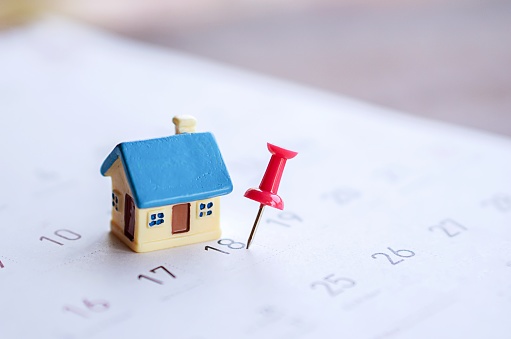 house model and red pin mark on calendar, due date for home payment ,property reminder concept background