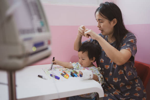 istock Mother with her son painting with crayon 1306433312