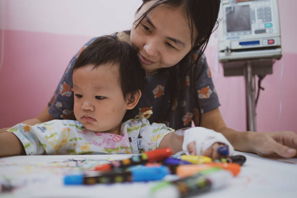 istock Mother with her son painting with crayon 1306433337