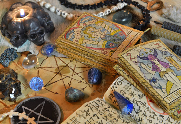 istock Fortune telling ritual with tarot cards, pentagram, black candle and crystals on witch table. 1306434988