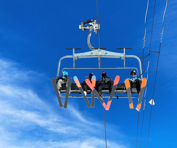 Skiers at chairlift ski resort Skiers at chairlift ski resort ski lift photos stock pictures, royalty-free photos & images
