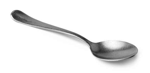 istock Silver spoon isolated on white background close up 1306435779