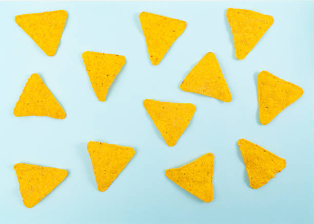 istock Nachos on a blue background. Mexican snack, corn tortilla chips. 1306437720