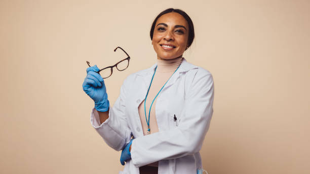 istock Happy female physician on brown background 1306438870