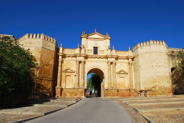 Cordoba gate entrance arch, Carmona, Spain. View of the Cordoba gate (Puerta de Cordoba) entrance arch and battlements, Carmona, Spain. carmona photos stock pictures, royalty-free photos & images