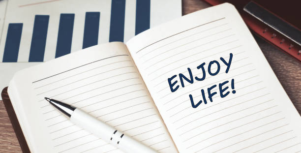 istock The words Enjoy Life written on a white notebook. Work and study concept 1306442920