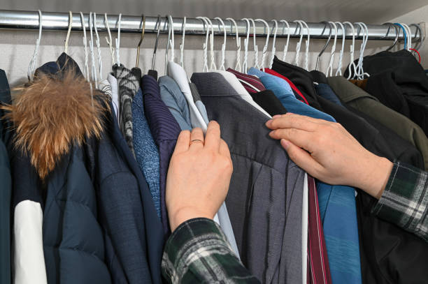 istock Various clothes hanging on hangers and filling the closet 1306443751