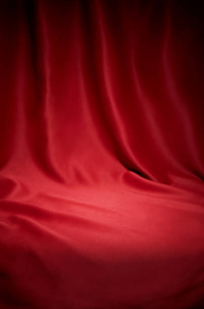 istock Red cloth waves texture background stage shot in table top for christmas background 1306444139