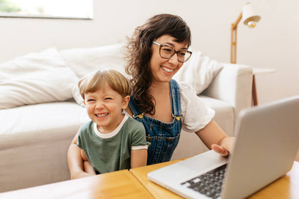 istock Woman working on laptop with her son 1306444274