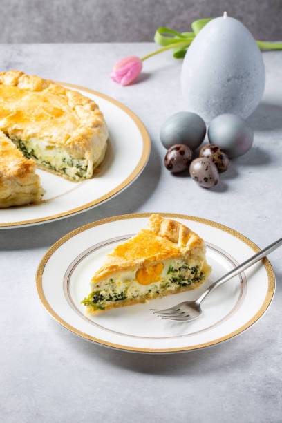 istock Torta Pasqualina. Traditional Italian savory Easter pie with spinach, chard, ricotta and whole eggs on gray background. 1306448268