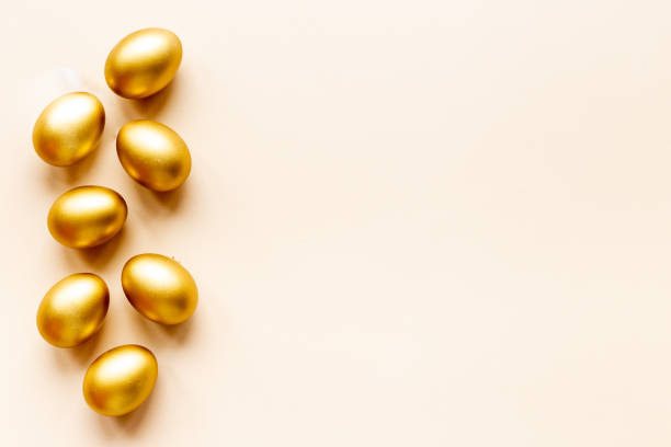 istock Golden eggs flat lay. Save money. Wealth and good luck symbol 1306449183