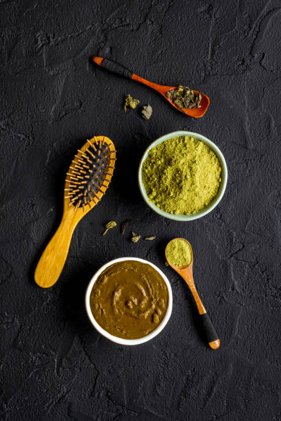 Herbal natural hair dye - henna with wooden comb stock photo