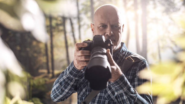 istock Photographer shooting in the wilderness 1306450237