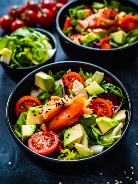 istock Smoked salmon, avocado and vegetables on black table 1306450354