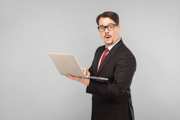 istock Business, gadgets,technologies. Man in shok. Holding note book 1306450492