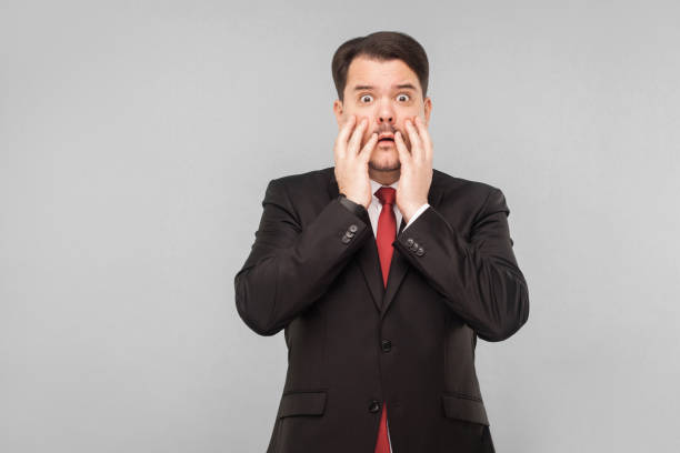 istock Business man in stress looking at camera 1306450499