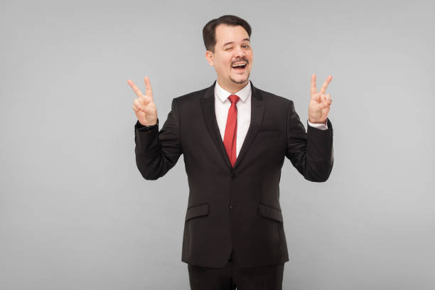 istock Businessman showing finger nomber four and wink 1306450502