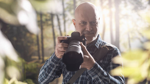 istock Professional photographer shooting in the wilderness 1306450664