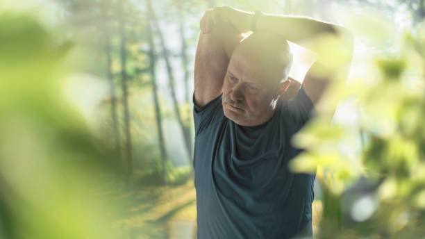 istock Middle aged man exercising outdoors 1306450945